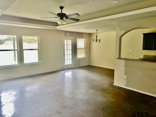 empty room with ceiling fan with notable chandelier