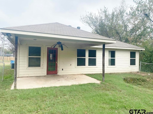 rear view of property with a patio, a yard, and ceiling fan