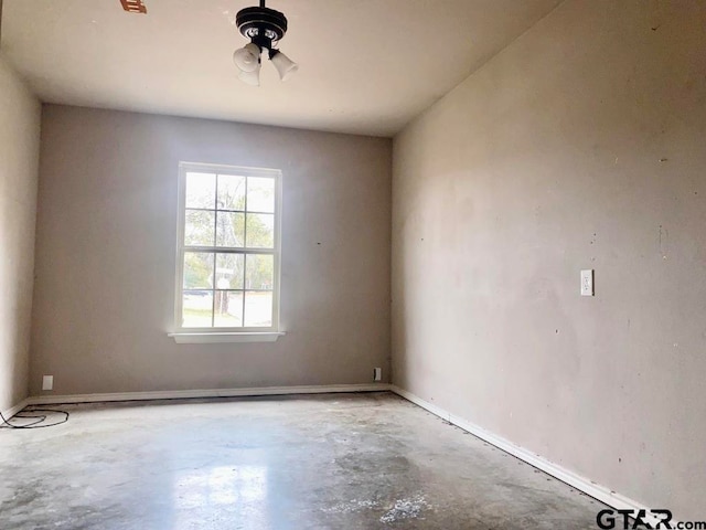 unfurnished room featuring concrete floors