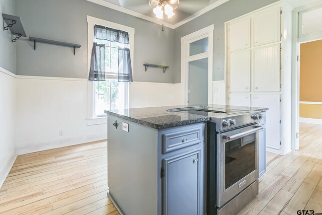 293 S Barron, Rusk, TX 75785 - kitchen with electric stove, light wood finished floors, a ceiling fan, crown molding, and dark stone counters