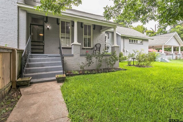 293 S Barron, Rusk, TX 75785 - view of exterior entry featuring brick siding and a porch