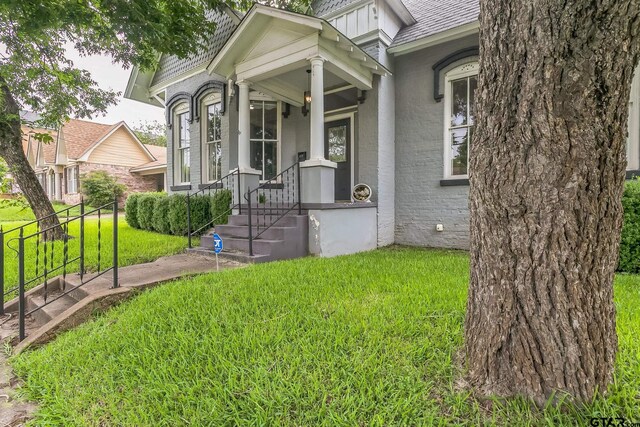 293 S Barron, Rusk, TX 75785 - view of front of property with a front yard, a shingled roof, and stucco siding