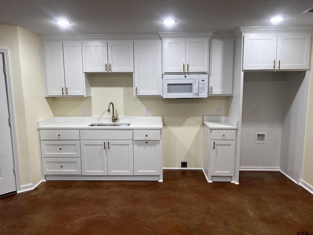 kitchen with white cabinets, dark colored carpet, and sink