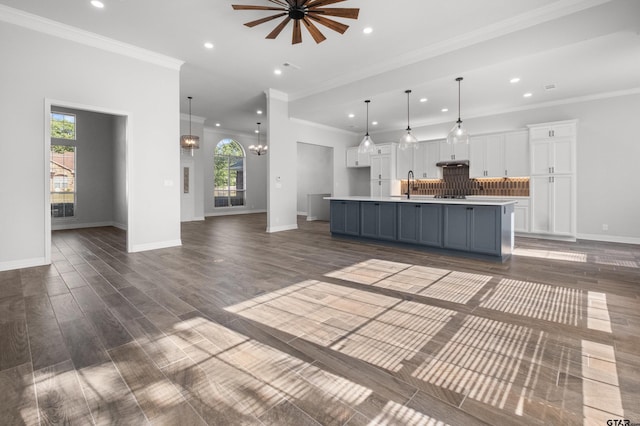 unfurnished living room with a sink, recessed lighting, and a healthy amount of sunlight