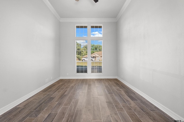 empty room with dark wood finished floors, crown molding, and a ceiling fan