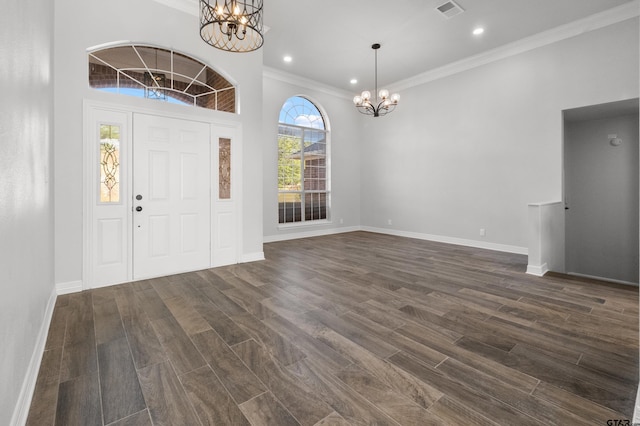entrance foyer featuring a notable chandelier, visible vents, crown molding, baseboards, and dark wood-style flooring