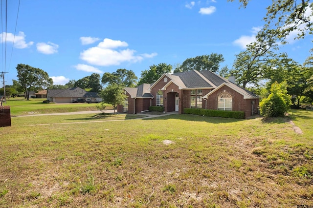 view of front of home featuring a front lawn and brick siding