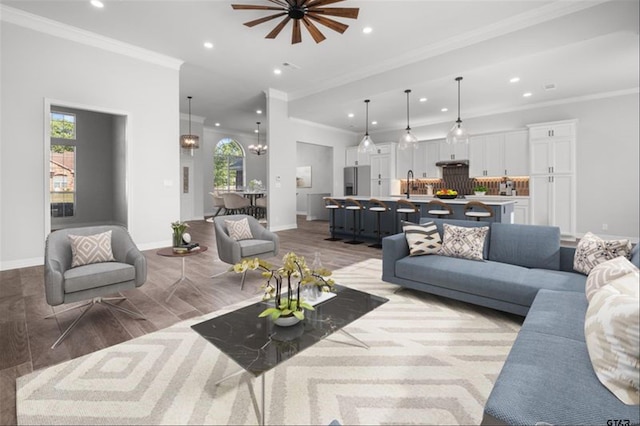 living room featuring plenty of natural light, recessed lighting, and ornamental molding