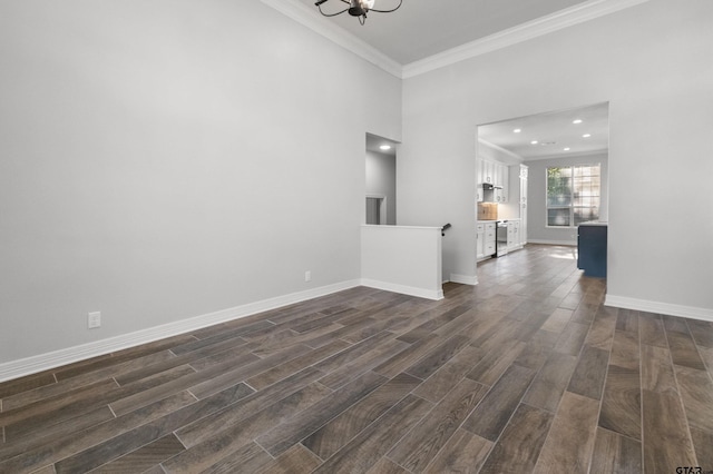 unfurnished room featuring crown molding, a chandelier, baseboards, dark wood-style floors, and recessed lighting