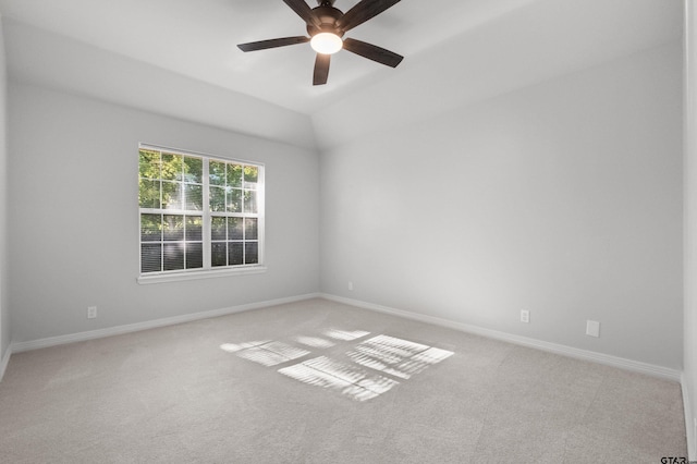 unfurnished room with carpet floors, lofted ceiling, baseboards, and ceiling fan