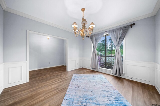 1261 Luann Ln, Tyler, TX 75703 - unfurnished dining area featuring a chandelier, crown molding, visible vents, and wood finished floors