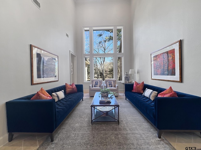 living room featuring a towering ceiling