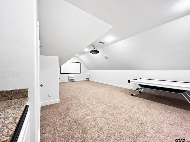 interior space featuring vaulted ceiling and carpet