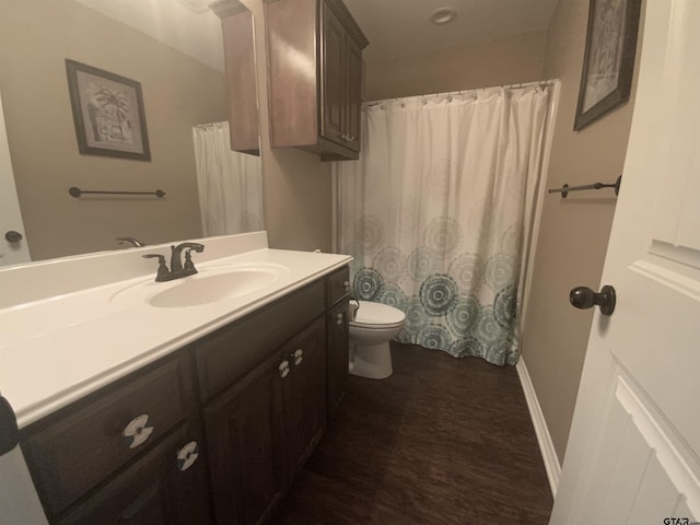 5848 Grace Ave, Tyler, TX 75707 - bathroom with wood finished floors, toilet, and vanity