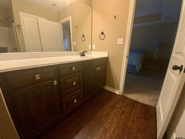 5848 Grace Ave, Tyler, TX 75707 - ensuite bathroom with wood finished floors, vanity, and baseboards