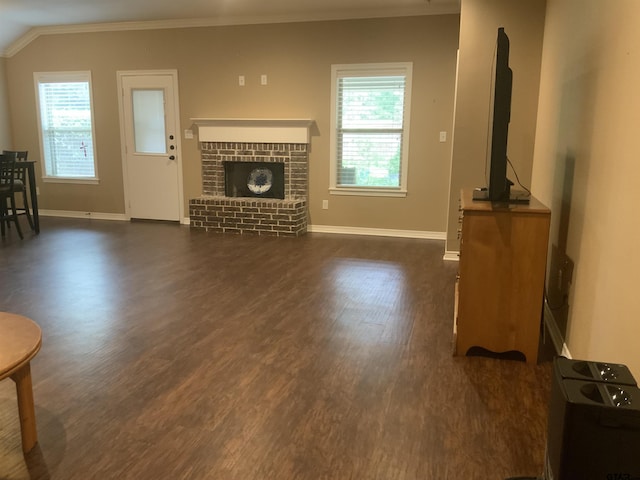 5848 Grace Ave, Tyler, TX 75707 - living area featuring crown molding, dark wood-style floors, baseboards, and a brick fireplace