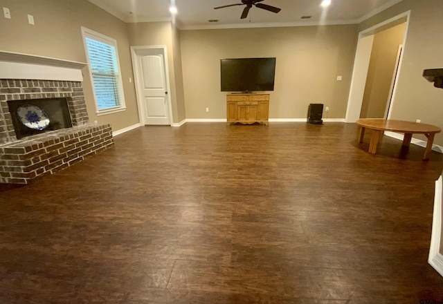5848 Grace Ave, Tyler, TX 75707 - unfurnished living room with ceiling fan, dark wood-style floors, baseboards, crown molding, and a brick fireplace