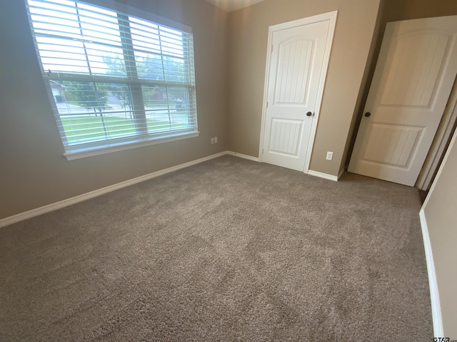 5848 Grace Ave, Tyler, TX 75707 - unfurnished bedroom with carpet and baseboards