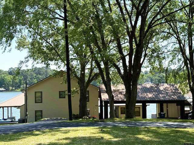 view of front facade with central air condition unit and a front lawn