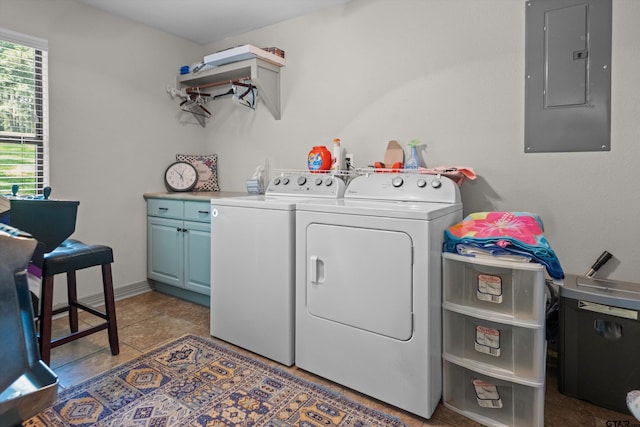 laundry room with cabinet space, electric panel, and washer and clothes dryer