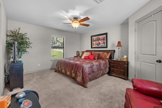 bedroom featuring ceiling fan, baseboards, and carpet