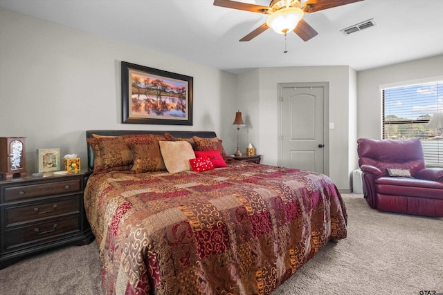 bedroom with carpet, visible vents, and ceiling fan