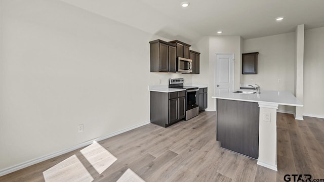 490 Burnett Trl, Canton, TX 75103 - kitchen featuring appliances with stainless steel finishes, light countertops, light wood-style floors, and recessed lighting