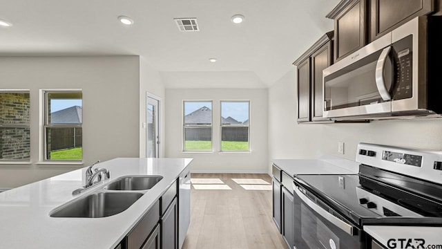 490 Burnett Trl, Canton, TX 75103 - kitchen with stainless steel appliances, light wood-type flooring, light countertops, dark brown cabinets, and recessed lighting
