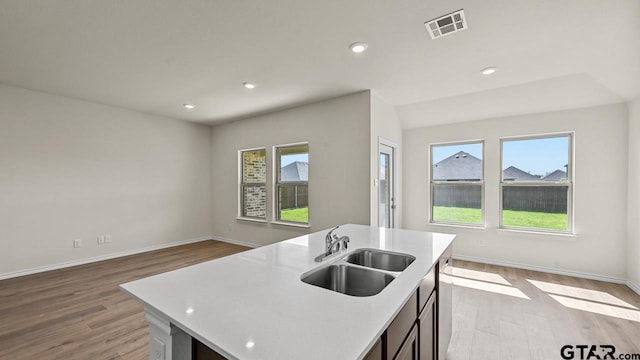 490 Burnett Trl, Canton, TX 75103 - kitchen with light wood-style floors, light countertops, a center island with sink, open floor plan, and recessed lighting