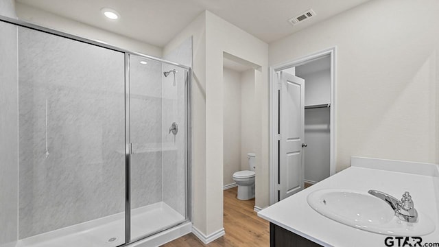 490 Burnett Trl, Canton, TX 75103 - full bathroom with a shower stall, wood finished floors, vanity, recessed lighting, and a walk in closet