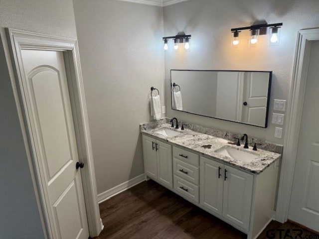 bathroom with vanity, wood-type flooring, and crown molding