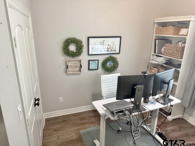 home office with dark hardwood / wood-style floors