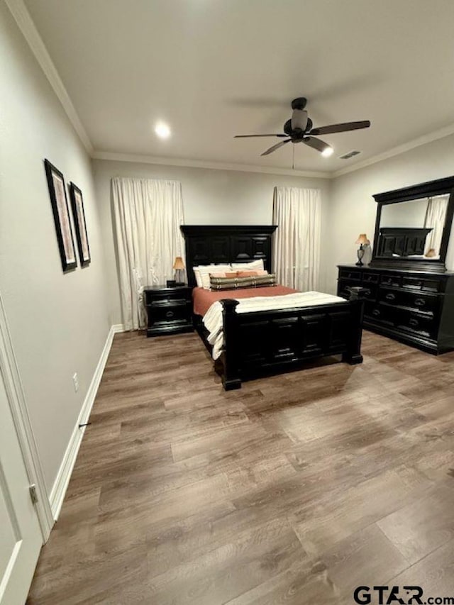 bedroom with ceiling fan, ornamental molding, and hardwood / wood-style floors