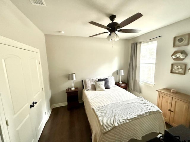 bedroom with ceiling fan, dark hardwood / wood-style flooring, and a closet