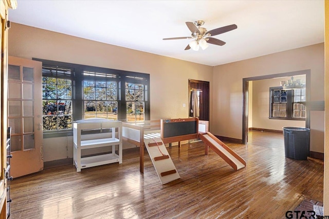 interior space with ceiling fan and wood-type flooring