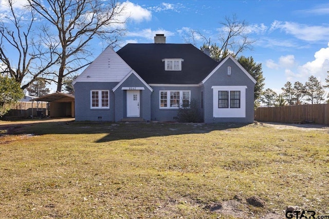 front facade with a carport and a front yard