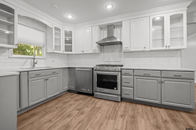 3316 S Cameron Ave, Tyler, TX 75701 - kitchen featuring gray cabinets, wall chimney range hood, stainless steel appliances, light wood finished floors, and light countertops