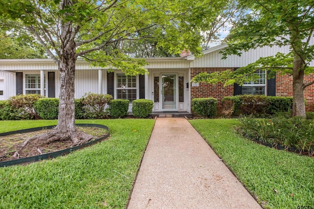 3316 S Cameron Ave, Tyler, TX 75701 - view of front of property featuring a front lawn, brick siding, and a chimney