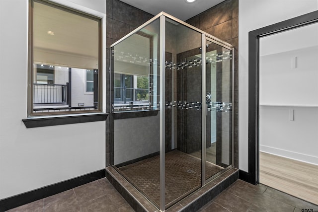 bathroom featuring wood-type flooring and a shower with shower door