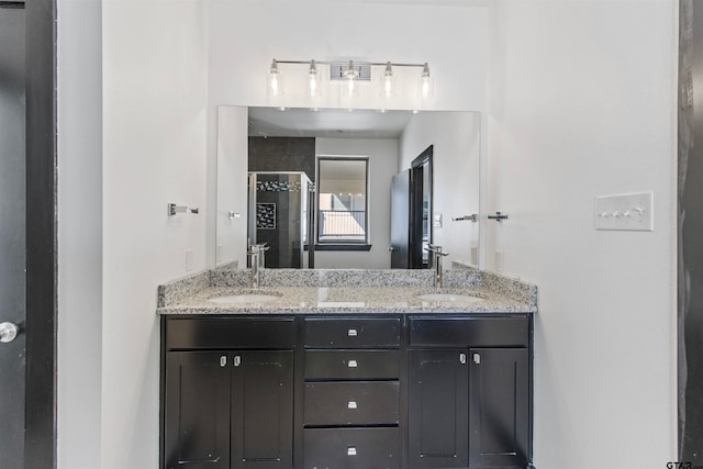 bathroom featuring vanity and a shower with door