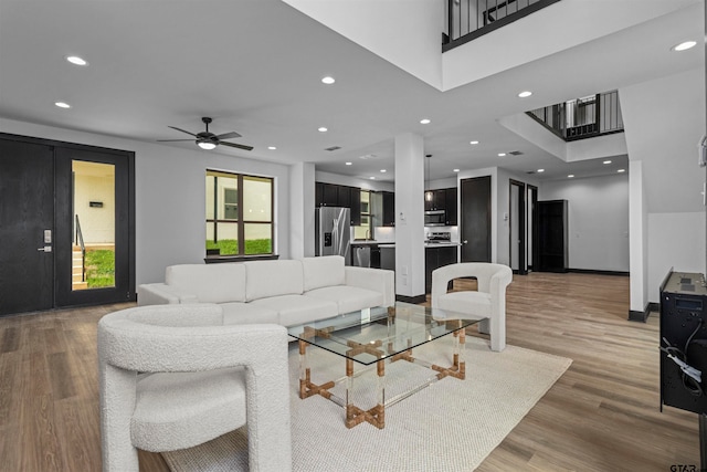 living room with hardwood / wood-style floors and ceiling fan