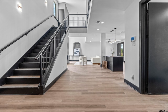 stairs with hardwood / wood-style floors