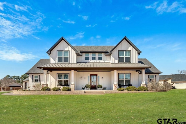 modern farmhouse style home featuring a front lawn and board and batten siding