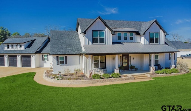 modern inspired farmhouse with a porch, board and batten siding, and a front lawn