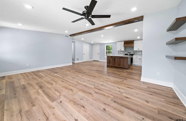 unfurnished living room featuring ceiling fan, beam ceiling, and light hardwood / wood-style flooring