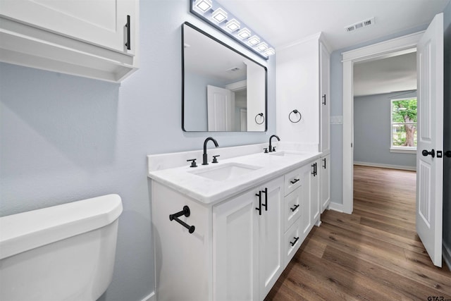 bathroom featuring hardwood / wood-style floors, vanity, and toilet