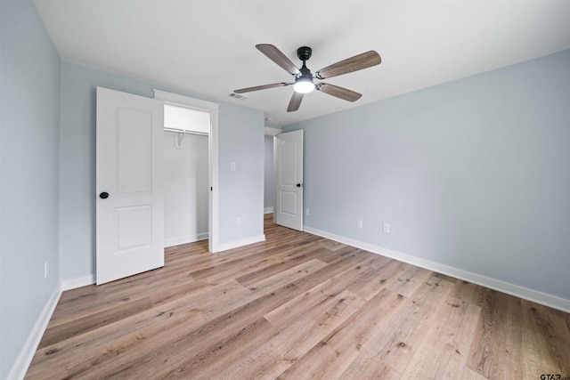 unfurnished bedroom featuring ceiling fan, a closet, and light hardwood / wood-style flooring