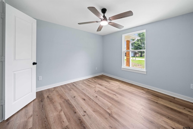 empty room with ceiling fan and light wood-type flooring