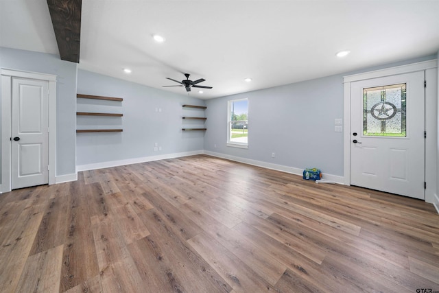 entryway featuring light wood-type flooring, beamed ceiling, a healthy amount of sunlight, and ceiling fan