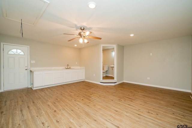 1021 N Montgomery St, Gilmer, TX 75644 - unfurnished living room with attic access, light wood finished floors, ceiling fan, and recessed lighting